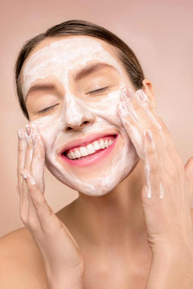 a woman cleanse her face with gentle facewash